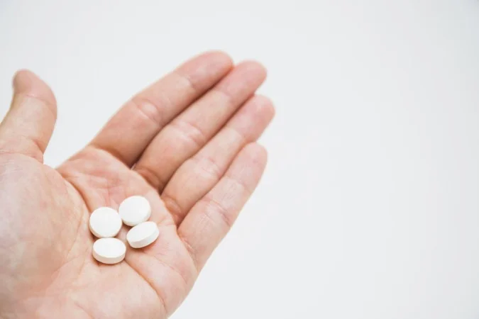 1_round-white-pills-hand-white-background--1--66850719